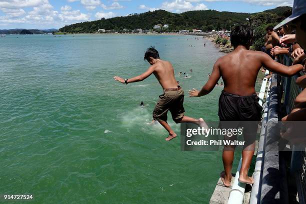 Children jump off the bridge at Te Ti Bay on February 6, 2018 in Waitangi, New Zealand. The Waitangi Day national holiday celebrates the signing of...