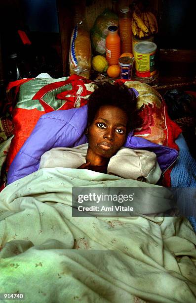 Malawian woman suffering from the HIV virus lies on the floor of a ward, because there were too many patients and not enough beds, at the Queen...