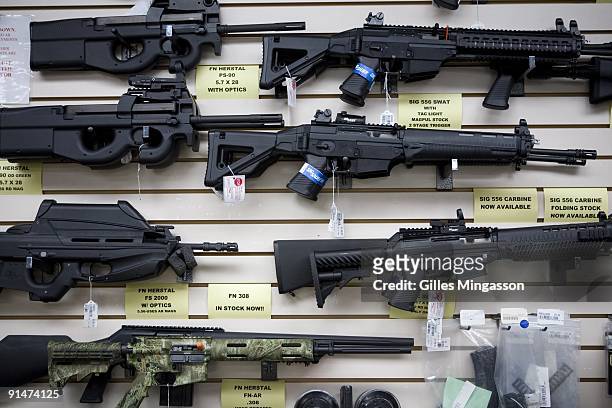 Semi-automatic weapons for sale are on display at Texas Gun, one of the 6,700 gun dealers located near the 2,000 miles long U.S.-Mexico border, where...