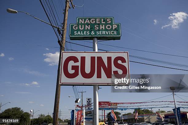 Sign indicates Nagel's Gun Shop, one of the 6,700 gun dealers located near the 2,000 miles long U.S.-Mexico border where guns and semi-automatics...