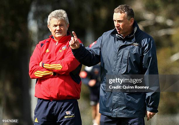 Neil Craig the coach of the Adelaide Crows AFL football team looks on as Ernie Merrick the coach of the Victory gives instructions during a Melbourne...