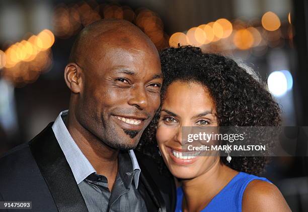 Actor Jimmy Jean-Louis and Evelyn Jean-Louis pose for photographers as they arrive on the red carpet for the premiere of the new Universal Pictures...