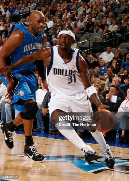 Jason Terry of the Dallas Mavericks drives against Vince Carter of the Orlando Magic in preseason action at the American Airlines Center on October...