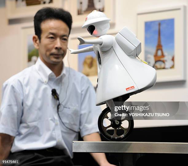 Japanese electronics parts maker Murata Electronics displays the company's new unicycle robot called the "Murata-seiko-chan" during a demonstration...