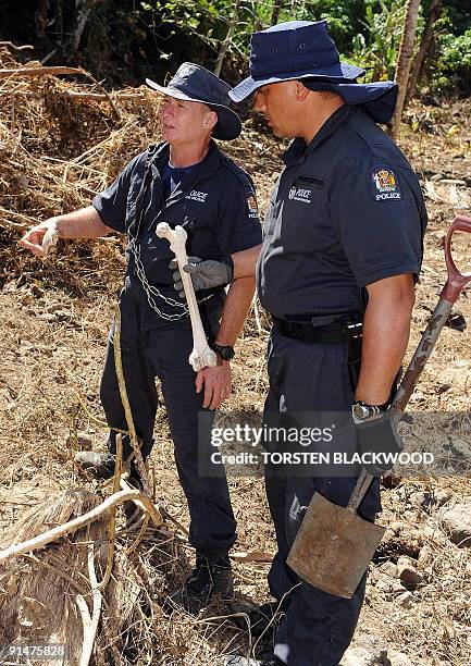 New Zealand Police Specialist Search Group personnel find human bones during the search for victims of the tsunami near Vava'u in Samoa on October 5,...