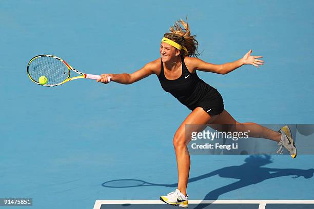 Victoria Azarenka of Belarus returns a shot against Maria Sharapova of Russia in her first round match during day five of the 2009 China Open at the...