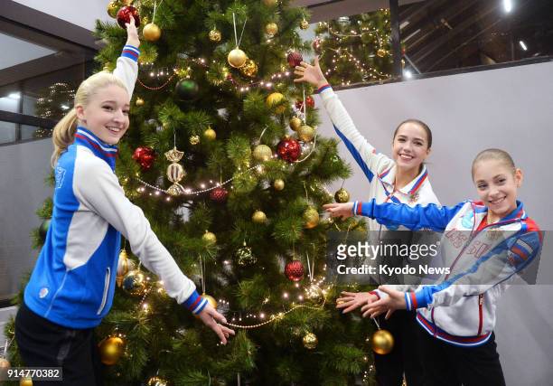 Photo taken on Dec. 23, 2017 shows Russian figure skater Alina Zagitova posing beside a Christmas tree after winning the women's title of the Russian...