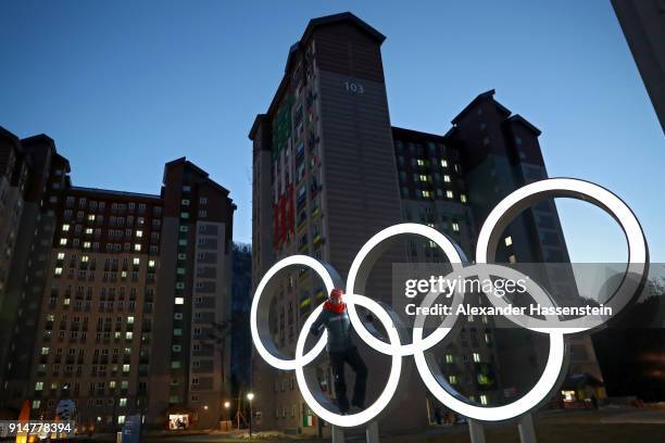 Member of Team Germany poses at the Olympic rings during previews ahead of the PyeongChang 2018 Winter Olympic Games at the Athletes' Village on...