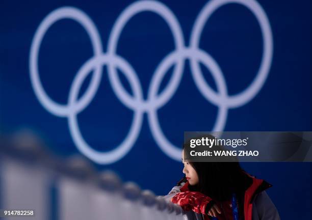 Volunteer watches as Japan's women ice hockey national team attend a training session at the Kwandong Hockey Centre's practice facility before the...