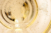 Many tiny bubbles in a champagne glass