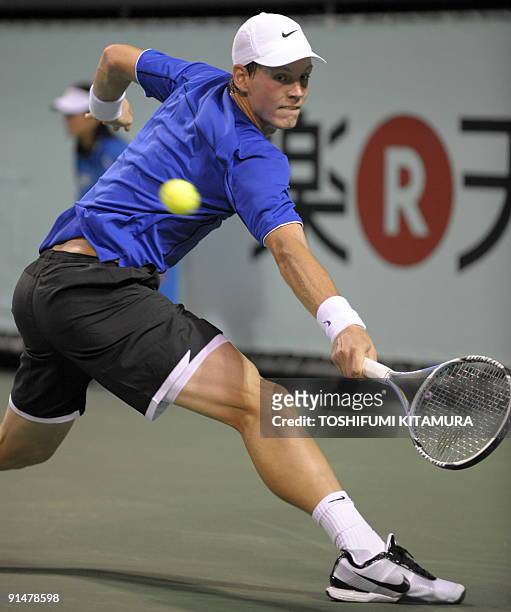 Tomas Berdych of Czech returns the ball against Japan's Go Soeda during their first round match in the Japan Open tennis tournament in Tokyo, on...