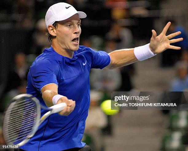 Tomas Berdych of Czech returns the ball against Japan's Go Soeda during their first round match in the Japan Open tennis tournament in Tokyo, on...