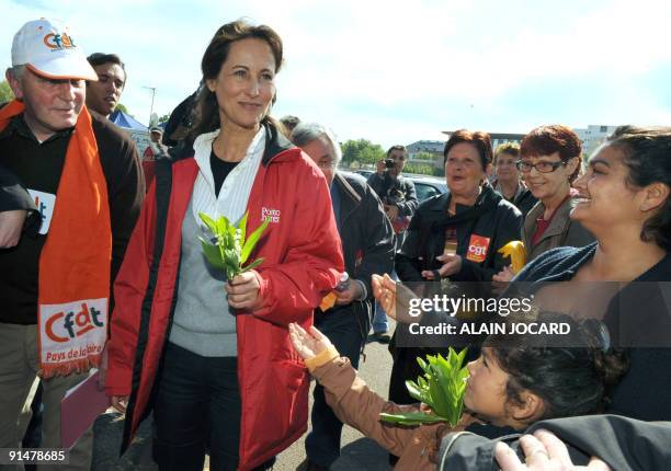 Des personnes offrent un brin de muguet à la présidente de la région Poitou-Charentes Ségolène Royal , le 01 mai 2009 à Niort, avant de participer à...