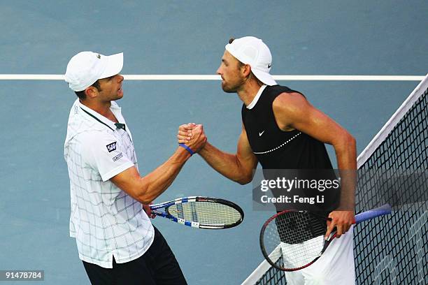 Andy Roddick of USA shakes hands with Lukasz Kubot of Poland after losing in his first round match during day five of the 2009 China Open at the...