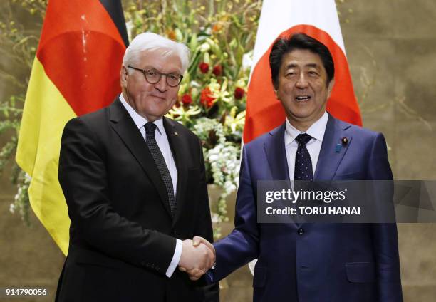 German President Frank-Walter Steinmeier shakes hands with Japan's Prime Minister Shinzo Abe at Abe's official residence in Tokyo on February 6,...