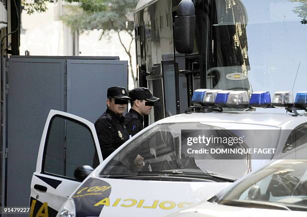 Spanish policemen stand in front of a Police truck used to transport Argentinian born Dutch pilot Julio Alberto Poch to the high court in Madrid on...