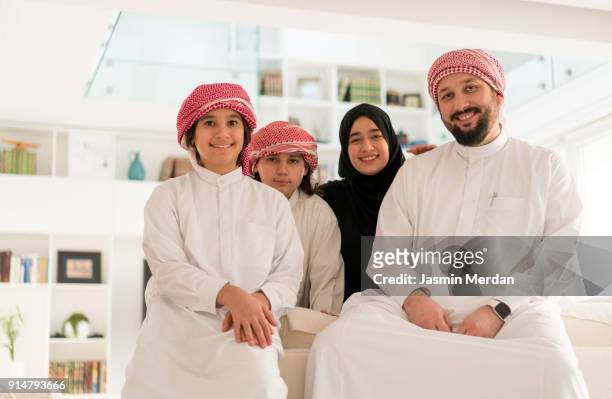 middle eastern young family at home - beautiful arabian girls stock-fotos und bilder