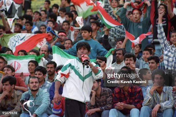 Iranian football fans cheer during a match against a foreign team at the Azadi Stadium in Tehran, July 1998. Known as Team Melli, the Iran national...