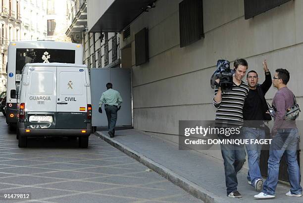 Journalist stand near a Police truck used to transport Argentinian born Dutch pilot Julio Alberto Poch to the high court in Madrid on October 6,...
