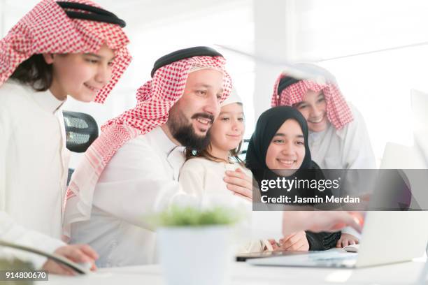 family using computer at home - saudi kids stock pictures, royalty-free photos & images