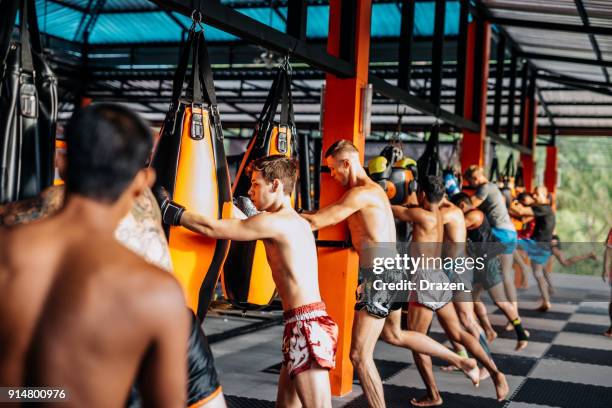group training for trainees at mma camp in thailand - muaythai boxing stock pictures, royalty-free photos & images