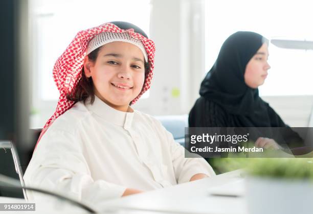 middle eastern students learning computer programming on laptops - arabic keyboard fotografías e imágenes de stock