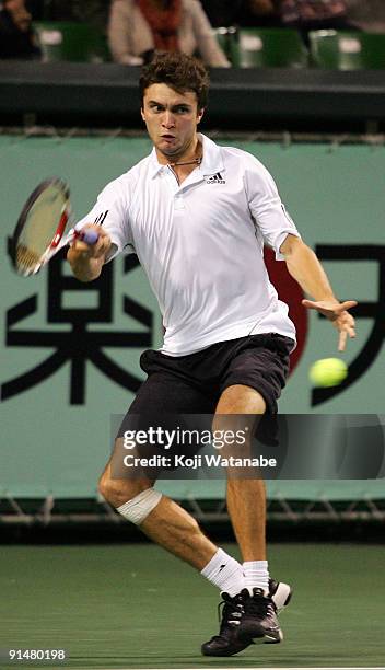 Gilles Simon of France plays a forehand in his match against Takao Suzuki of Japan during day two of the Rakuten Open Tennis tournament at Ariake...