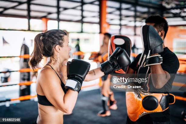 teamwork with personal trainer in muay thai camp in thailand - young woman using elbow punch - muay thai elbow stock pictures, royalty-free photos & images