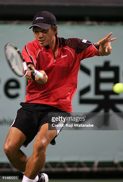 Takao Suzuki of Japan plays a forehand in his match against Gilles Simon of France during day two of the Rakuten Open Tennis tournament at Ariake...