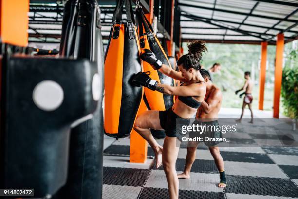 boxing for men and women in thailand - recreation or professional training - muaythai boxing stock pictures, royalty-free photos & images