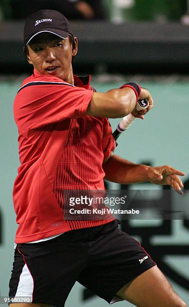 Takao Suzuki of Japan plays a shot in his match against Gilles Simon of France during day two of the Rakuten Open Tennis tournament at Ariake...