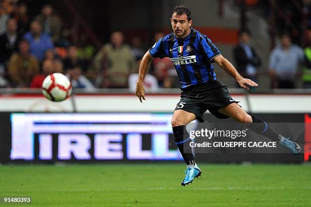 Inter Milan's Serbian midfielder Dejan Stankovic kicks the ball to score during their Serie A football match Inter Milan vs Udinese at San Siro...
