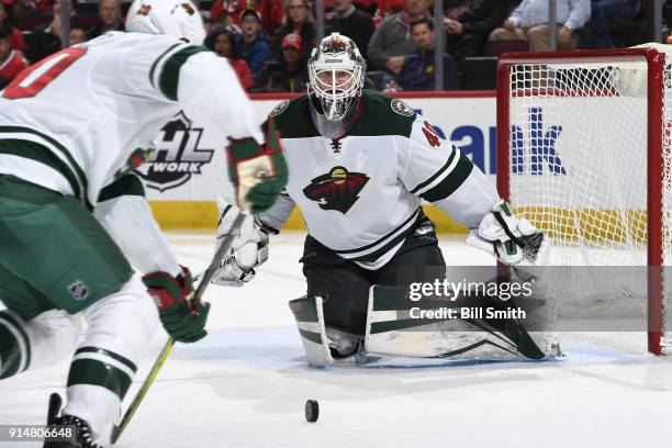 Goalie Devan Dubnyk of the Minnesota Wild watches the puck in the third period against the Chicago Blackhawks at the United Center on January 10,...