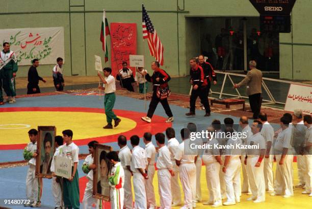 Wrestling team arrive at the opening ceremony of the Takhti Cup in Tehran, 17th February 1998. They are holding their national flag, while the...