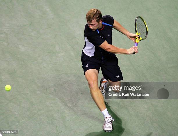 Andrey Golubev of Kazakhstan plays a backhand in his match against Fabrice Santoro of France during day two of the Rakuten Open Tennis tournament at...