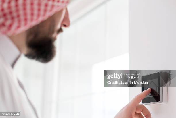 arabian man in smart home - saudi home stock pictures, royalty-free photos & images