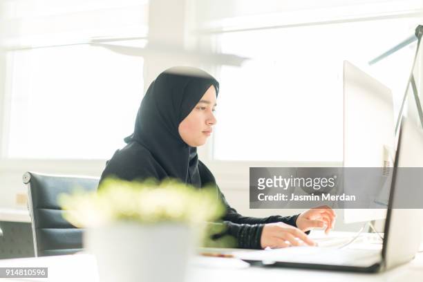 Young Arabic female working in startup office