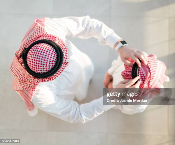 father and son talking - saudi relaxing stock pictures, royalty-free photos & images