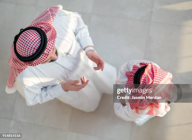 father and son talking - saudi relaxing stock pictures, royalty-free photos & images