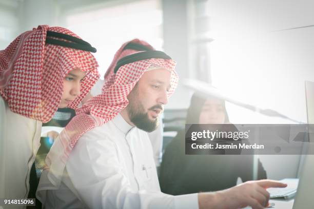 middle eastern family together on computer - old saudi man stock pictures, royalty-free photos & images