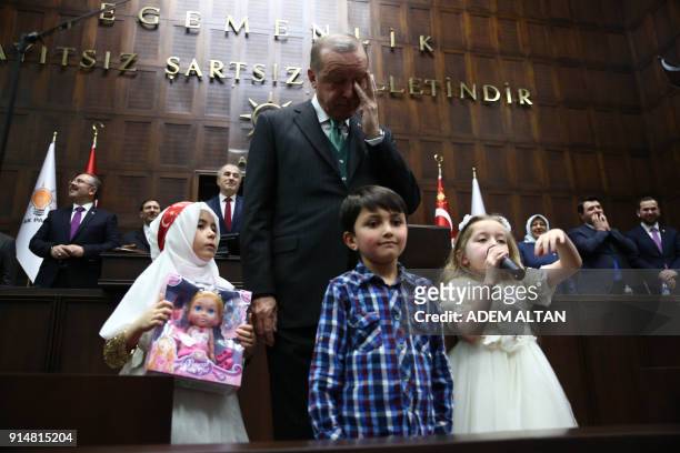President of Turkey and Leader of the Justice and Development Party Recep Tayyip Erdogan gives presents to children during a parliamentary group...