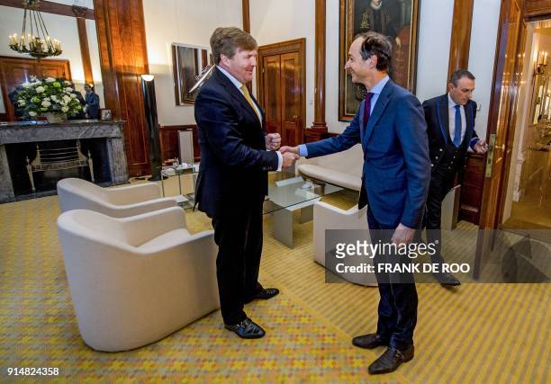 King Willem-Alexander of The Netherlands shakes hands with Dutch Minister of Economic Affairs and Climate Eric Wiebes during a meeting at the Royal...