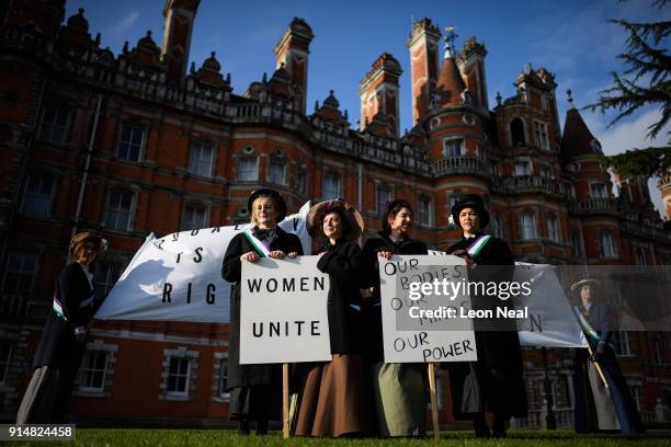 Students pose after re-creating a suffragette protest march through the town centre, at Royal Holloway, University of London on February 6, 2018 in...