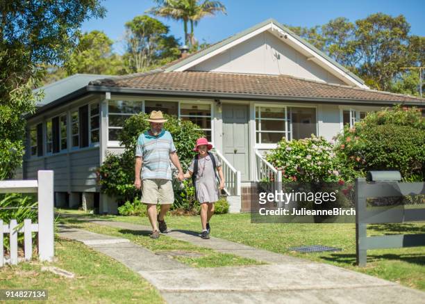 senior walking his granddaughter to school - suburb stock pictures, royalty-free photos & images