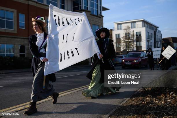 Student Hope Williams leads the group while they re-create a suffragette protest march through the town centre, at Royal Holloway, University of...