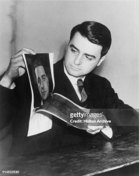 American scientist and inventor Edwin Herbert Land demonstrates his instant camera or Land Camera, manufactured by Polaroid, circa 1947.