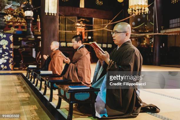 monks praying in a japanese temple - ceremony stock pictures, royalty-free photos & images