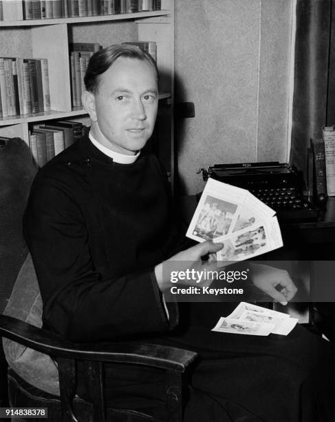 Reverend D. H. Large, Vicar of St James's Church, Merton, Surrey, who is protesting the sale of saucy seaside postcards in the UK, 28th July 1953. He...