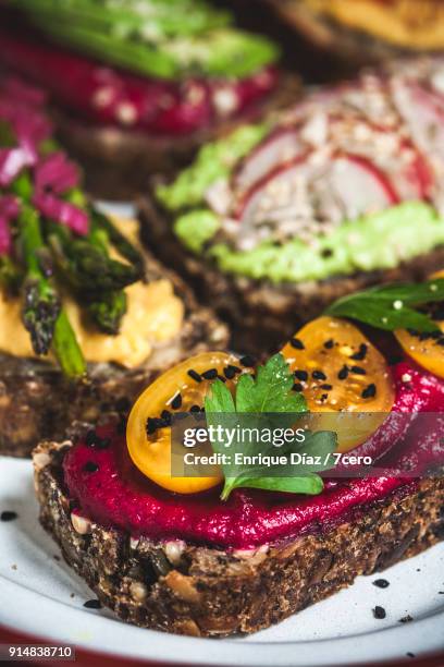 multicoloured hummus on toasts extreme close up - italian parsley stock pictures, royalty-free photos & images