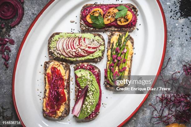 multicoloured hummus on toasts vertical - rye bread stock pictures, royalty-free photos & images